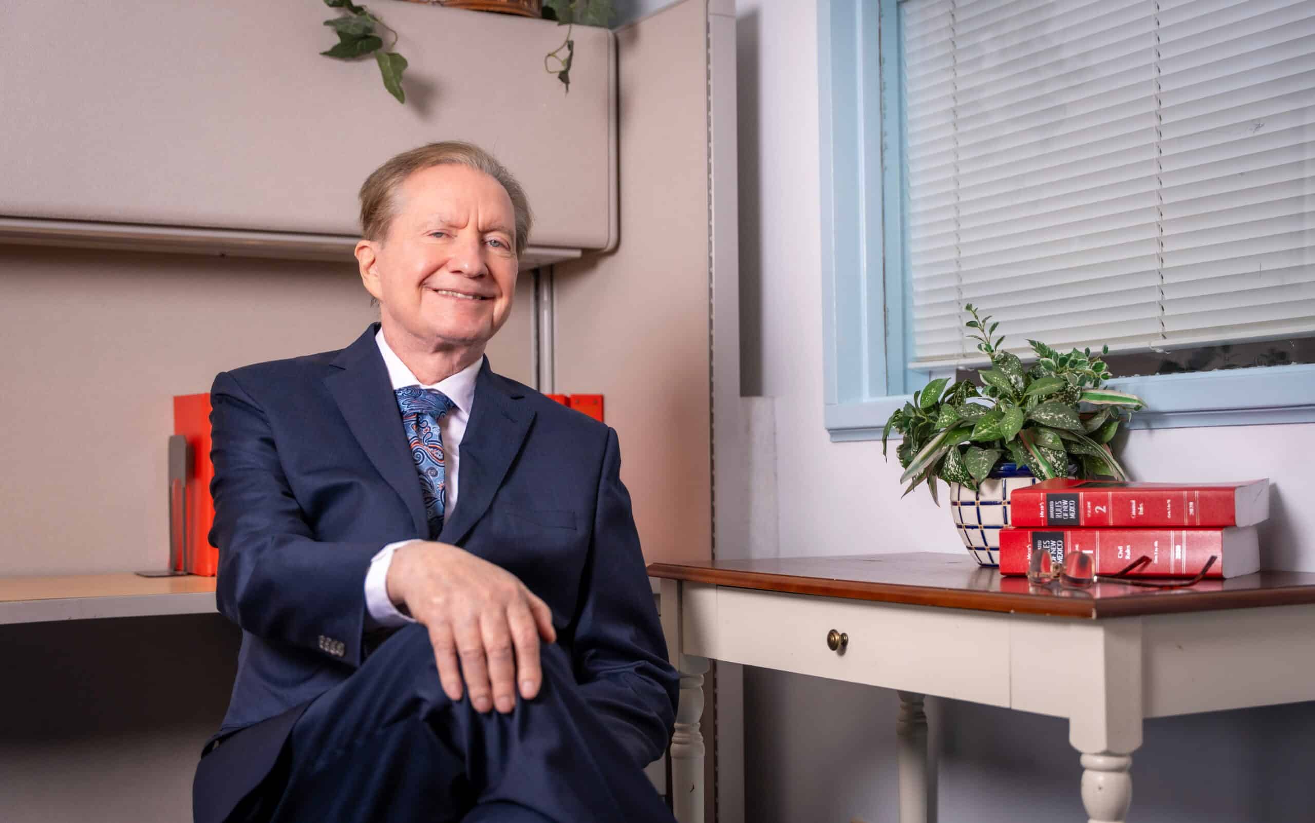 Tim Chelpaty smiling in his Las Cruces law office